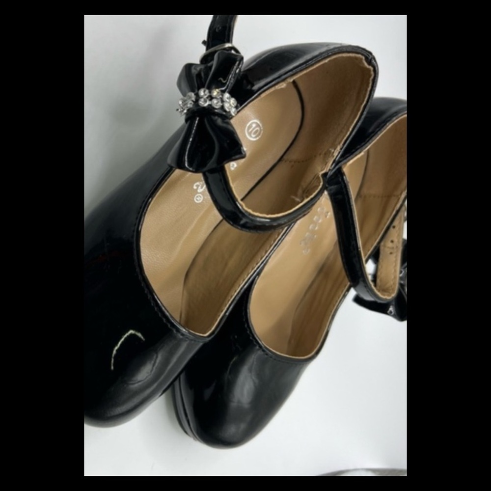 Black patent leather little girl shoes.